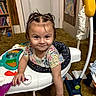 toddler, child, baby, smiling, sitting, activity_walker, toy, playroom, indoor, portrait, face, hair_bows, floral_shirt, colorful, bookshelf, books, door, carpet, children_toys, happy