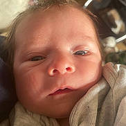 Alfie is registered to the contest to win money with this photo: baby, newborn, face, closeup, blanket, infant, skin, sleepy, expression, person, soft, clothing, head, young, cute, indoors, portrait, human, newborn_baby, wrapped