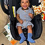 Benjamin is registered to the contest to win money with this photo: accessories, baby, clothing, cushion, face, footwear, furniture, happy, head, homedecor, hosiery, jewelry, necklace, person, photography, portrait, shoe, sitting, sock, t_shirt