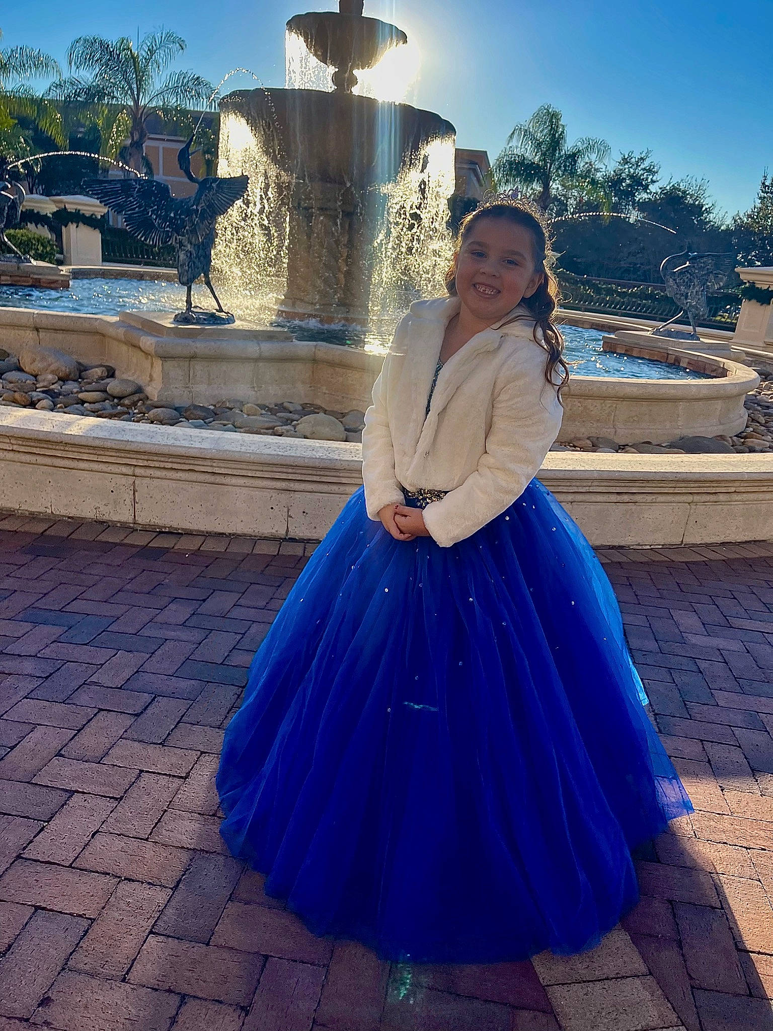 Ellyana is registered to the contest to win money with this photo: azure, blue, clothing, dress, electric_blue, event, fashion_design, flash_photography, formal_wear, fun, gown, happy, hat, joy, leisure, pattern, person, ruffle, sky, travel