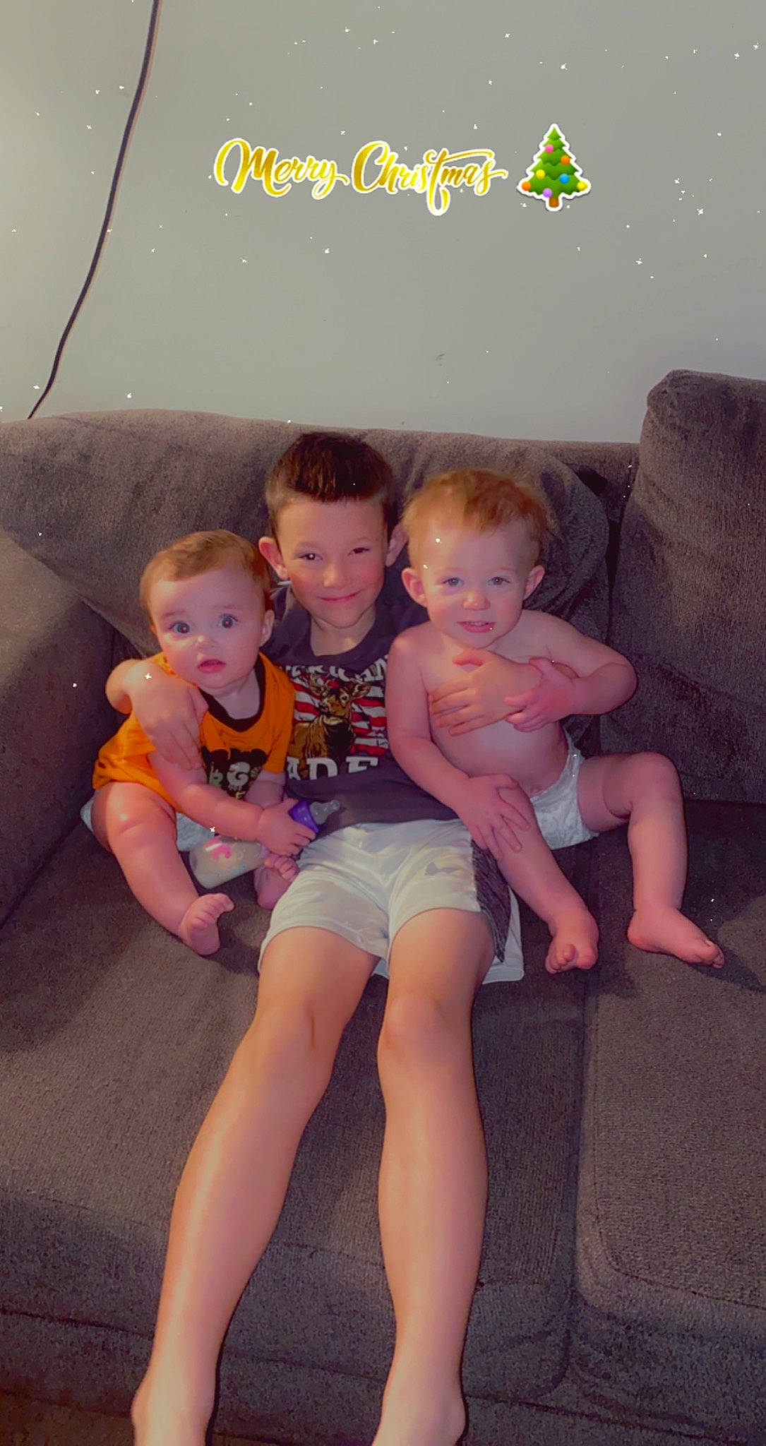 Jordan is registered to the contest to win money with this photo: baby_toddler_clothing, comfort, couch, eye, face, finger, fun, happy, iris, joy, lap, leg, person, pink, shorts, skin, smile, standing, surprise, t_shirt