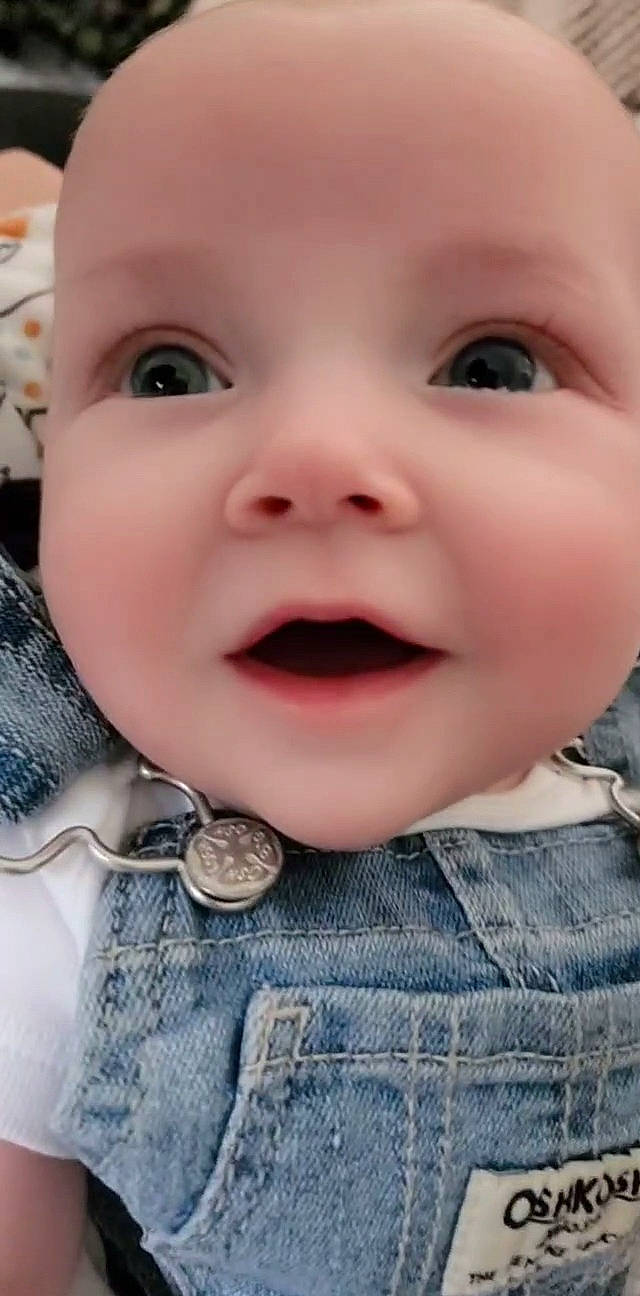 Jade is registered to the contest to win money with this photo: baby_toddler_clothing, blue, cheek, chin, eye, eyebrow, eyelash, finger, gesture, grey, happy, iris, lip, mouth, nose, outerwear, person, skin, sleeve, smile