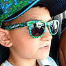 boy, cap, car_interior, casual, child, closeup, ear, eyewear, face, hat, kid, minecraft_hat, portrait, profile_view, reflection, seatbelt, sleeveless_shirt, summer_clothing, sunglasses, vehicle
