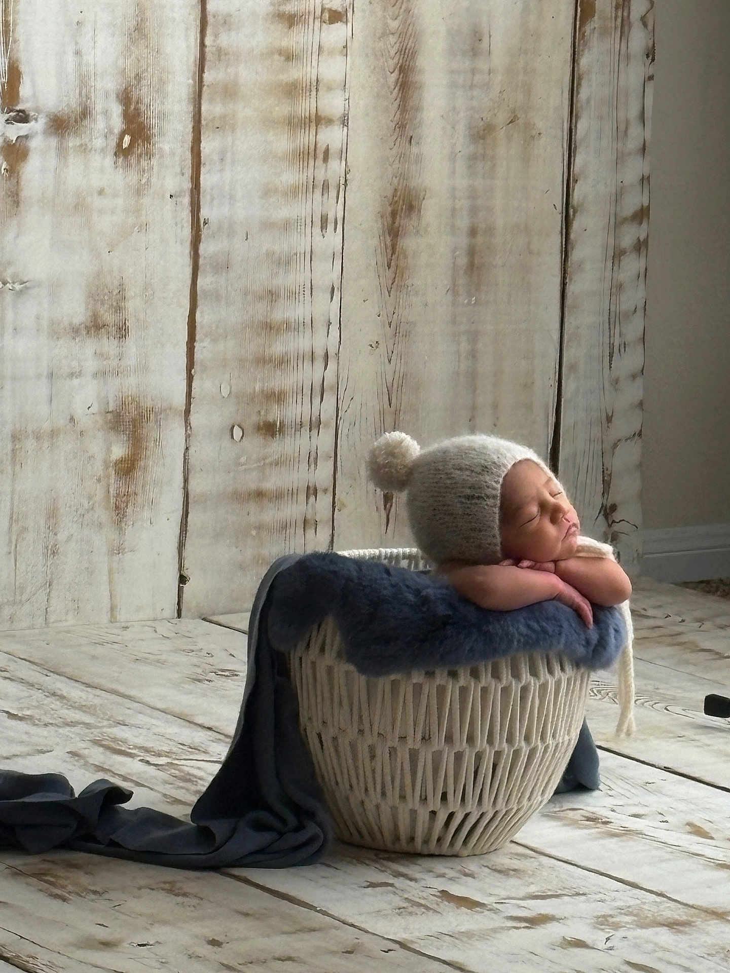 Adiel joined the competition — help win amazing prizes! baby, newborn, sleeping, basket, blanket, hat, pom_pom, wooden_floor, wooden_wall, cozy, soft, resting, indoors, peaceful, portrait, infant, knitted, warm, cute, child