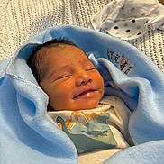 Adiel joined the competition — help win amazing prizes! newborn, baby, smiling, wrapped, blanket, blue, infant, sleeping, cute, cozy, knit, soft, child, portrait, clothing, dinosaur, happy, resting, indoors, peaceful