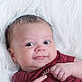 Jasiah is registered to the contest to win money with this photo: baby, infant, smile, face, eyes, hand, skin, hair, clothing, maroon, white_background, fluffy, portrait, cute, child, newborn, expression, lying_down, soft_texture, closeup