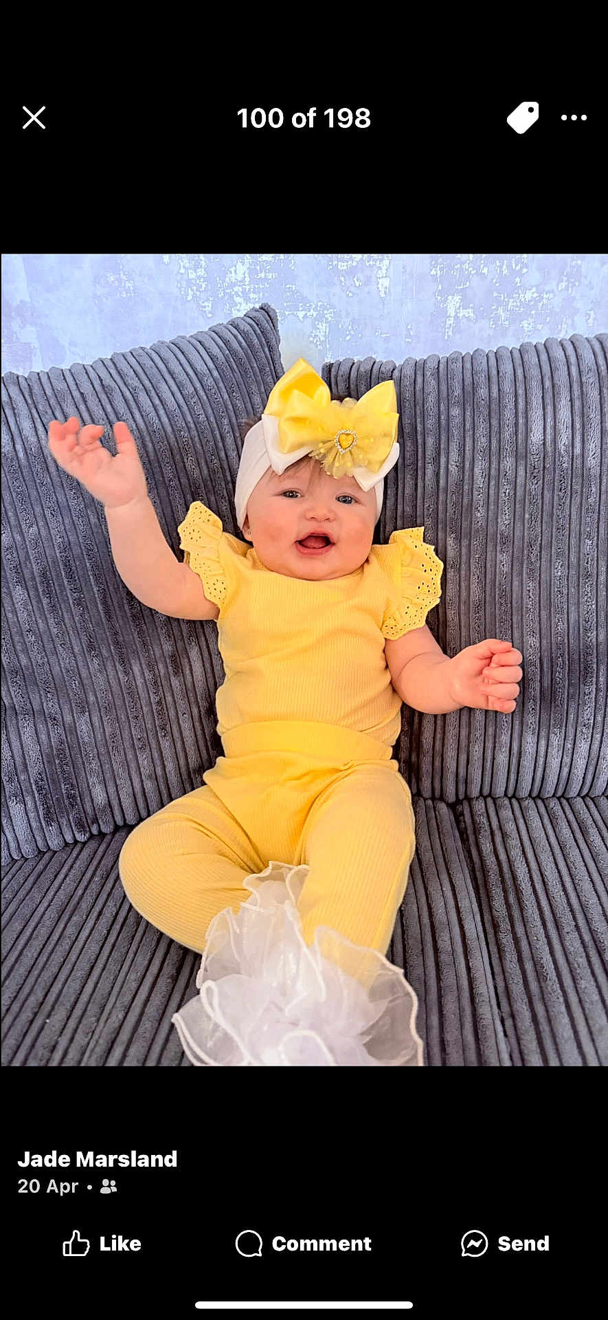Marliya-Mae is registered to the contest to win money with this photo: baby, child, yellow_clothing, headband, bow, smiling, happy, sitting, couch, gray_couch, plush, indoor, portrait, cute, infant, person, toddler, baby_girl, closeup, fabric