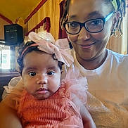 Zari'Yah joined the competition — help win amazing prizes! baby, child, closeup, clothing, curtains, cute, dreadlocks, face, family, glasses, happy, headband, indoor, person, pink_dress, portrait, smile, toddler, woman, wooden_paneling