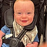 Brodie is registered to the contest to win money with this photo: baby, child, smiling, stroller, blue_outfit, bib, happy, infant, face, hand, seatbelt, child_seat, cute, indoor, person, closeup, young_child, safety_harness, baby_boy, portrait