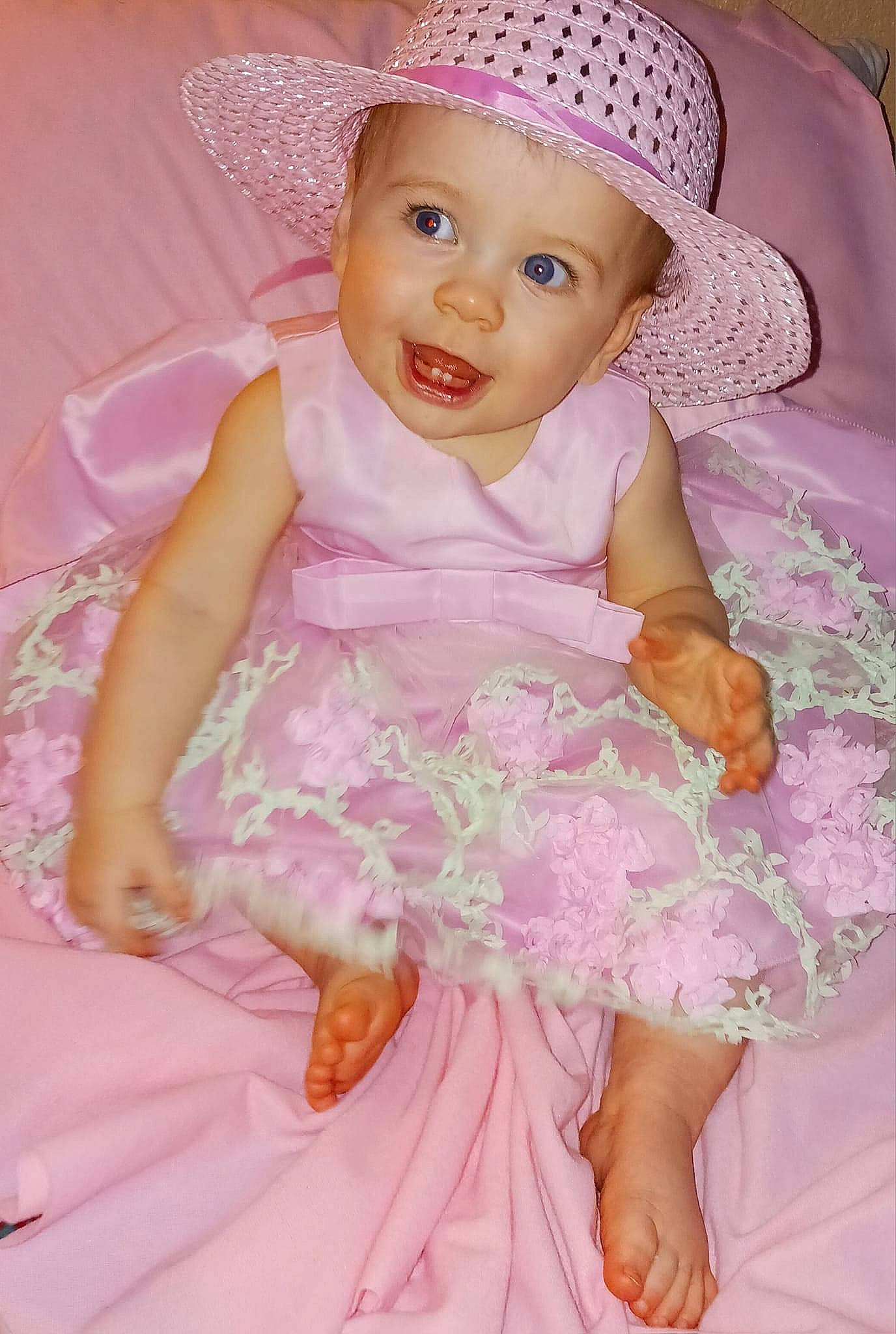 Remington joined the competition — help win amazing prizes! baby_toddler_clothing, child, day_dress, dress, embellishment, happy, hat, headgear, headwear, magenta, one_piece_garment, person, petal, pink, product, purple, skin, sleeve, smile, sun_hat