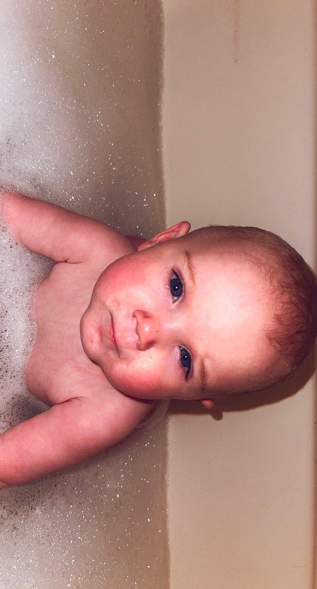 Bella is registered to the contest to win money with this photo: arm, baby, bathing, cheek, chest, ear, eyelash, finger, gesture, hair, hand, human_body, iris, jaw, lip, mouth, neck, nose, person, skin