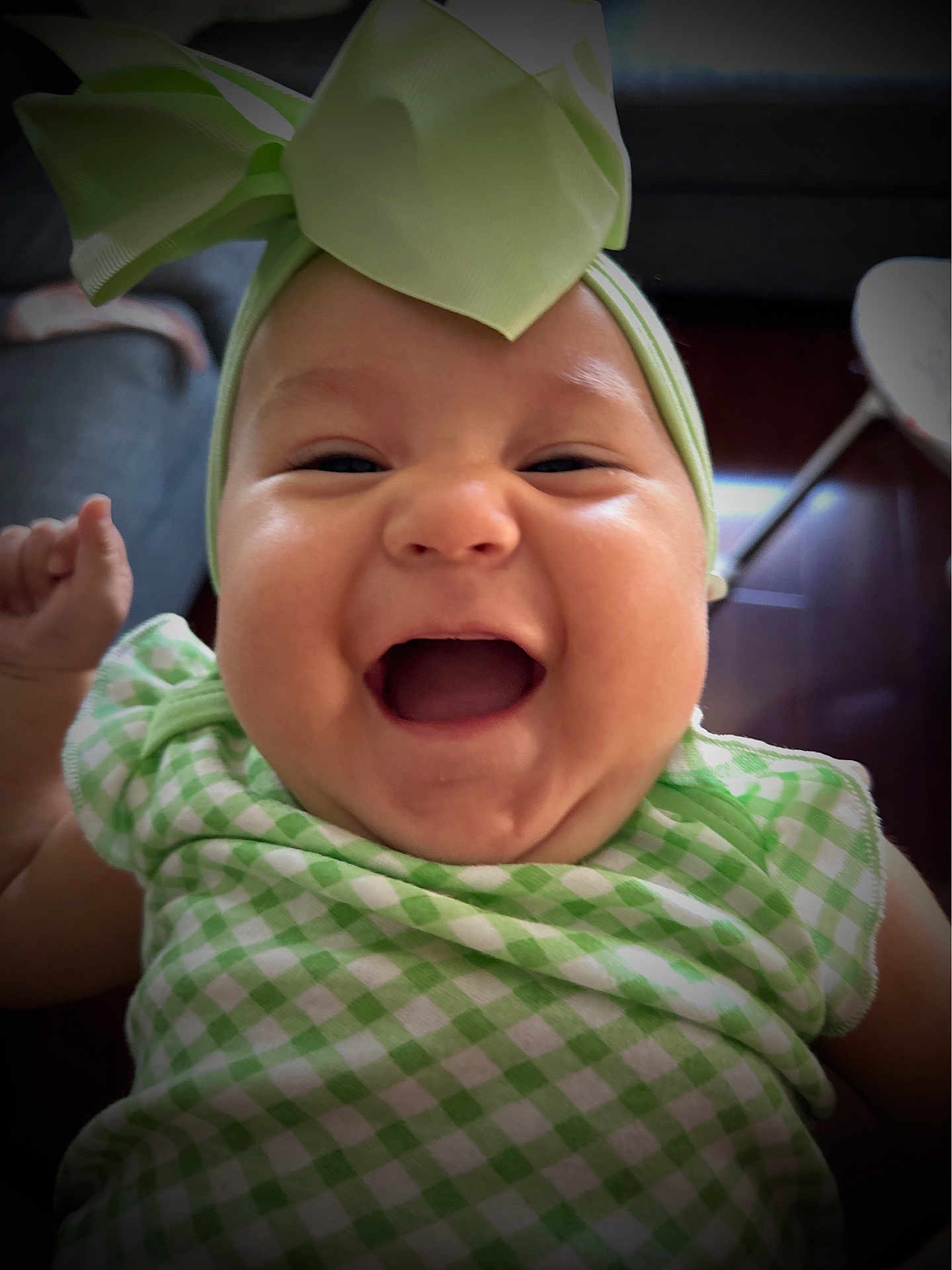 Trinity is registered to the contest to win money with this photo: baby, child, smiling, laughing, headband, bow, green_clothing, chubby_cheeks, portrait, indoor, happy, cute, infant, closeup, person, cheerful, face, toddler, apparel, fashion