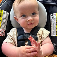 Corbin is registered to the contest to win money with this photo: baby, child, car_seat, blue_eyes, plush_toy, hands, clothing, seatbelt, infant, cute, closeup, indoor, person, headrest, straps, soft_toy, expression, skin, sitting, young