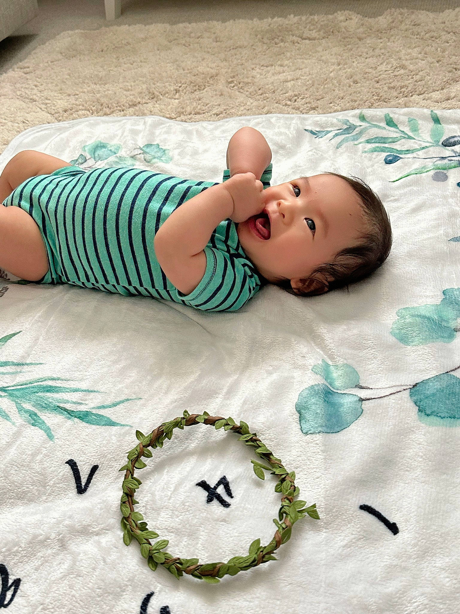 Leonardo is registered to the contest to win money with this photo: aqua, baby, baby_toddler_clothing, bedding, child, comfort, cool, dress, fashion_accessory, flooring, font, grass, green, jewellery, leisure, linens, pattern, person, t_shirt, textile