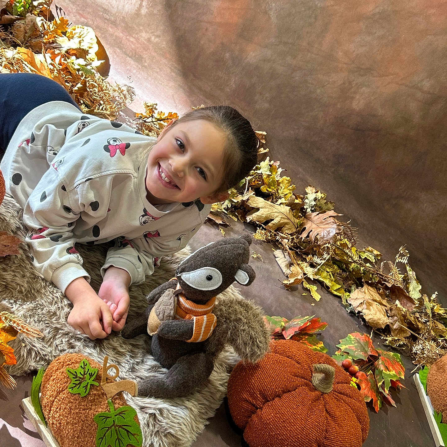 Kayla a rejoint le concours — aidez-le/la à gagner de superbes lots ! autumn_leaves, child, costume_props, cozy, fabric, fall_decor, fur_rug, girl, happy, indoor, knitted_pumpkin, photography, playful, plush_squirrel, portrait, pumpkin, seasonal_props, smile, smiling_face, stuffed_animal