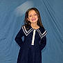 Kayla a rejoint le concours — aidez-le/la à gagner de superbes lots ! child, girl, smile, dress, navy_dress, portrait, backdrop, fabric, long_hair, standing, pose, teeth, button, sleeves, studio_flash, indoor, cute, fashion, young_child, person