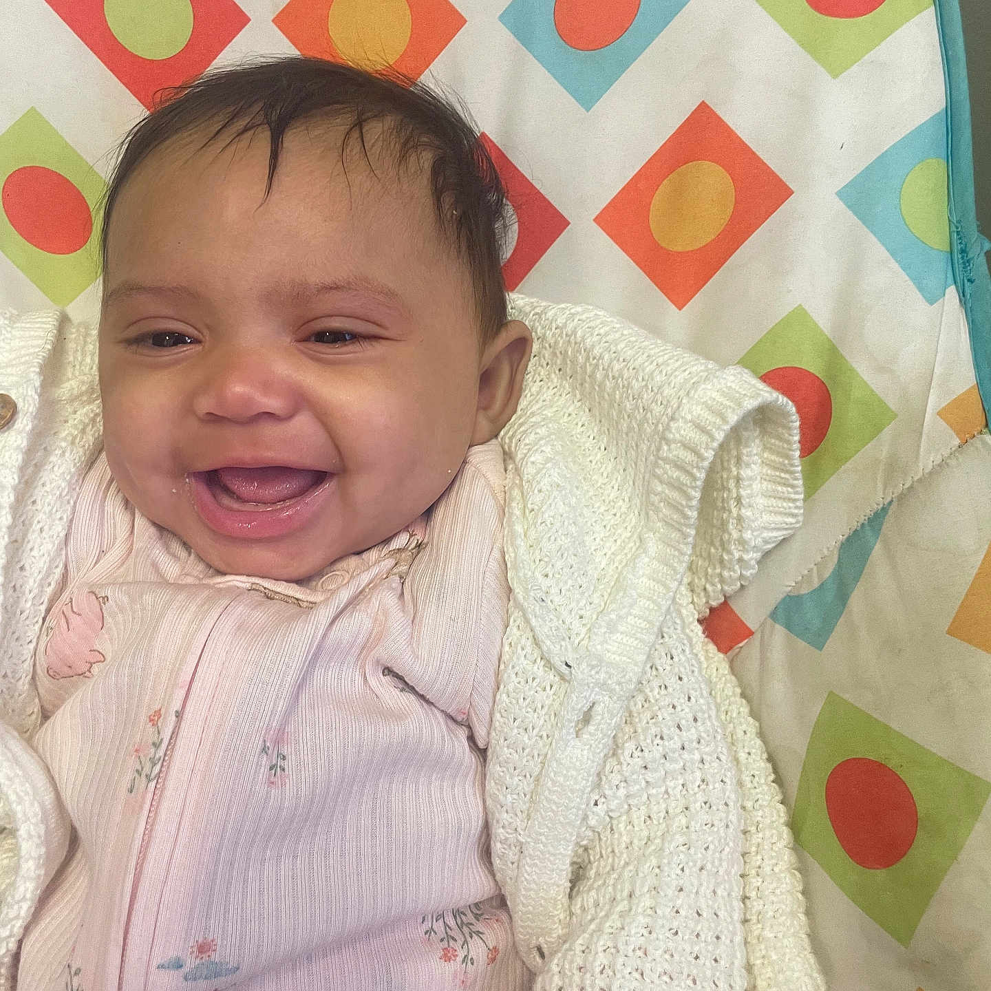 Harmani joined the competition — help win amazing prizes! baby, babylaughing, bed, blanket, clothing, cushion, face, furniture, happy, head, homedecor, knitwear, laughing, newborn, person, photography, portrait, quilt, smile, sweater