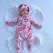 Parker joined the competition — help win amazing prizes! baby, snow, snow_angel, pink_snowsuit, floral_pattern, hood, hat, cold_weather, winter, outdoor, infant, face, cute, lying_down, frost, child, warm_clothing, footwear, nature, play