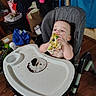 birthday, cake, celebration, child, clothing, eating, face, floor, food, furniture, hands, high_chair, indoor, messy, person, plate, room, sprinkles, toddler, toy