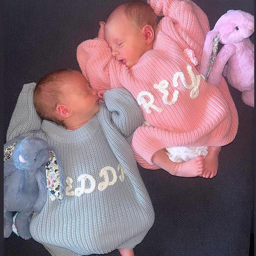 Freddie And Freya is registered to the contest to win money with this photo: baby, bed, blanket, clothing, couch, cushion, face, furniture, head, homedecor, knitwear, newborn, people, person, photography, portrait, sleeping, sweater, t_shirt, toy