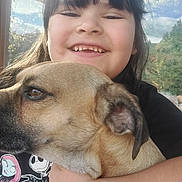 Natalia joined the competition — help win amazing prizes! animal, bangs, black_shirt, brown_dog, cartoon_shirt, child, closeup, dog, face, happy, hugging, indoors, long_hair, nature, pet, portrait, selfie, smiling, sunlight, window