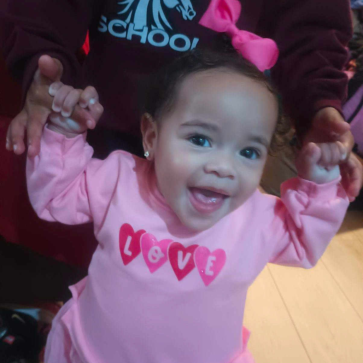 Malia is registered to the contest to win money with this photo: accessories, baby, bodypart, clothing, coat, dress, face, happy, head, jewelry, laughing, mouth, necklace, person, photography, portrait, purple, smile, t_shirt, teeth