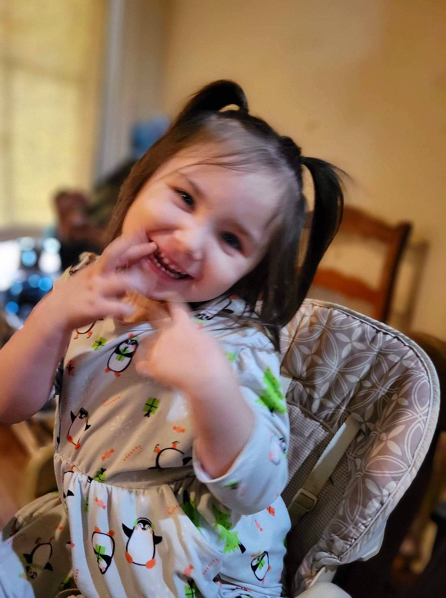 Gabbriella is registered to the contest to win money with this photo: ceremony, chair, child, costume, dress, event, fashion_design, fun, hairstyle, happy, necklace, pattern, person, portrait_photography, room, sitting, skin, smile, toddler, tradition