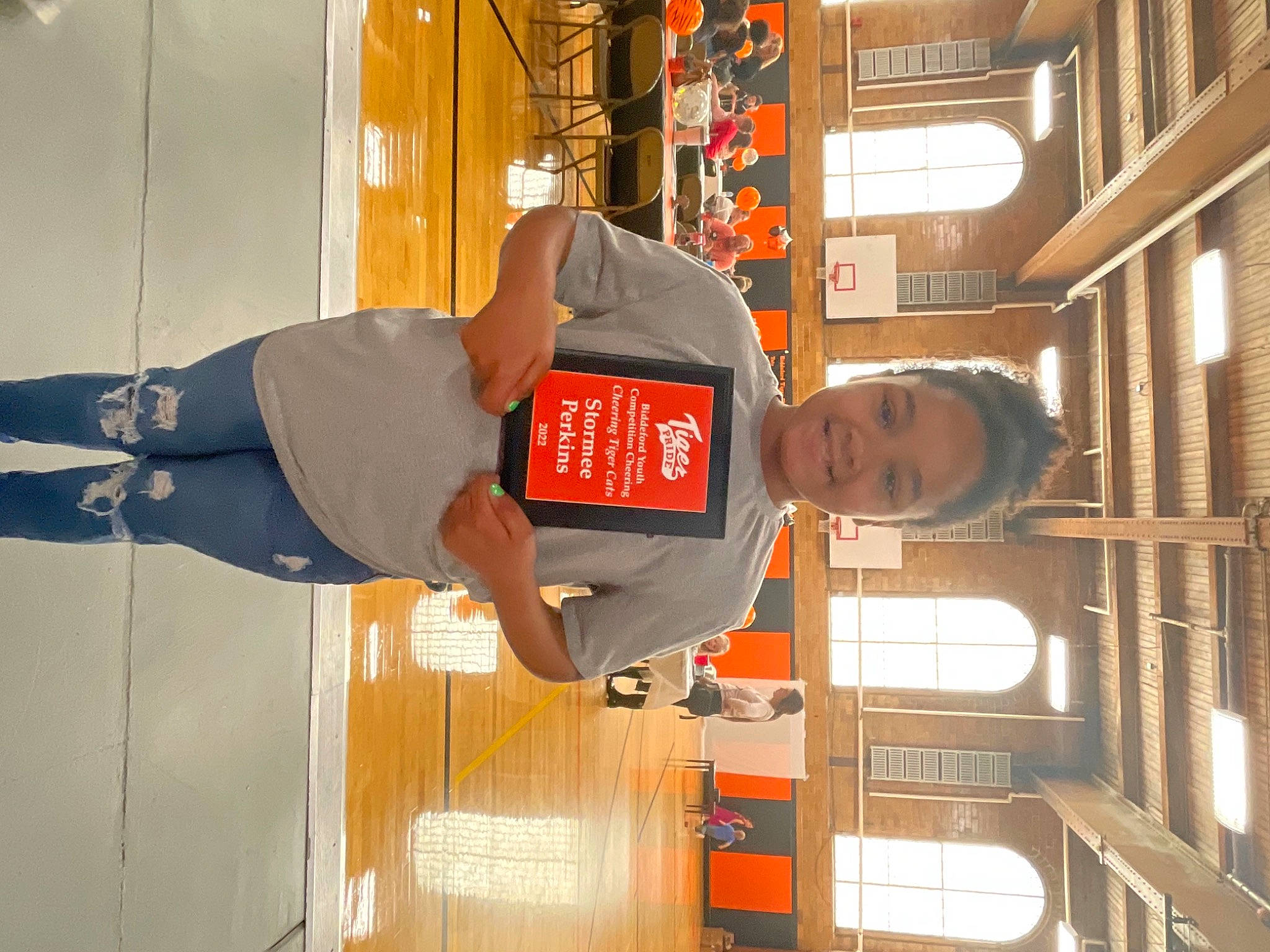 Stormee is registered to the contest to win money with this photo: balance, building, door, elbow, engineering, flooring, hat, human_leg, joy, knee, orange, person, room, shorts, sleeve, sportswear, t_shirt, thigh, varnish, walking_shoe