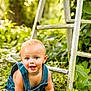 baby, child, crawling, denim_overalls, blue_eyes, outdoor, greenery, plants, wooden_ladder, nature, smiling, happy, infant, grass, sunlight, portrait, cute, playful, garden, young_child