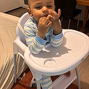 Mateo participe au concours pour gagner de l'argent avec cette photo : baby, blanket, chair, child, curly_hair, cute, dining_room, eating, face, foot, hands, highchair, home_interior, pajamas, portrait, shoe, striped_pajamas, table, toddler, tray