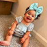 baby, child, infant, smiling, happy, portrait, indoor, carpet, floor, bow, headband, dress, sitting, curly_hair, brown_hair, face, eyes, feet, home, photography