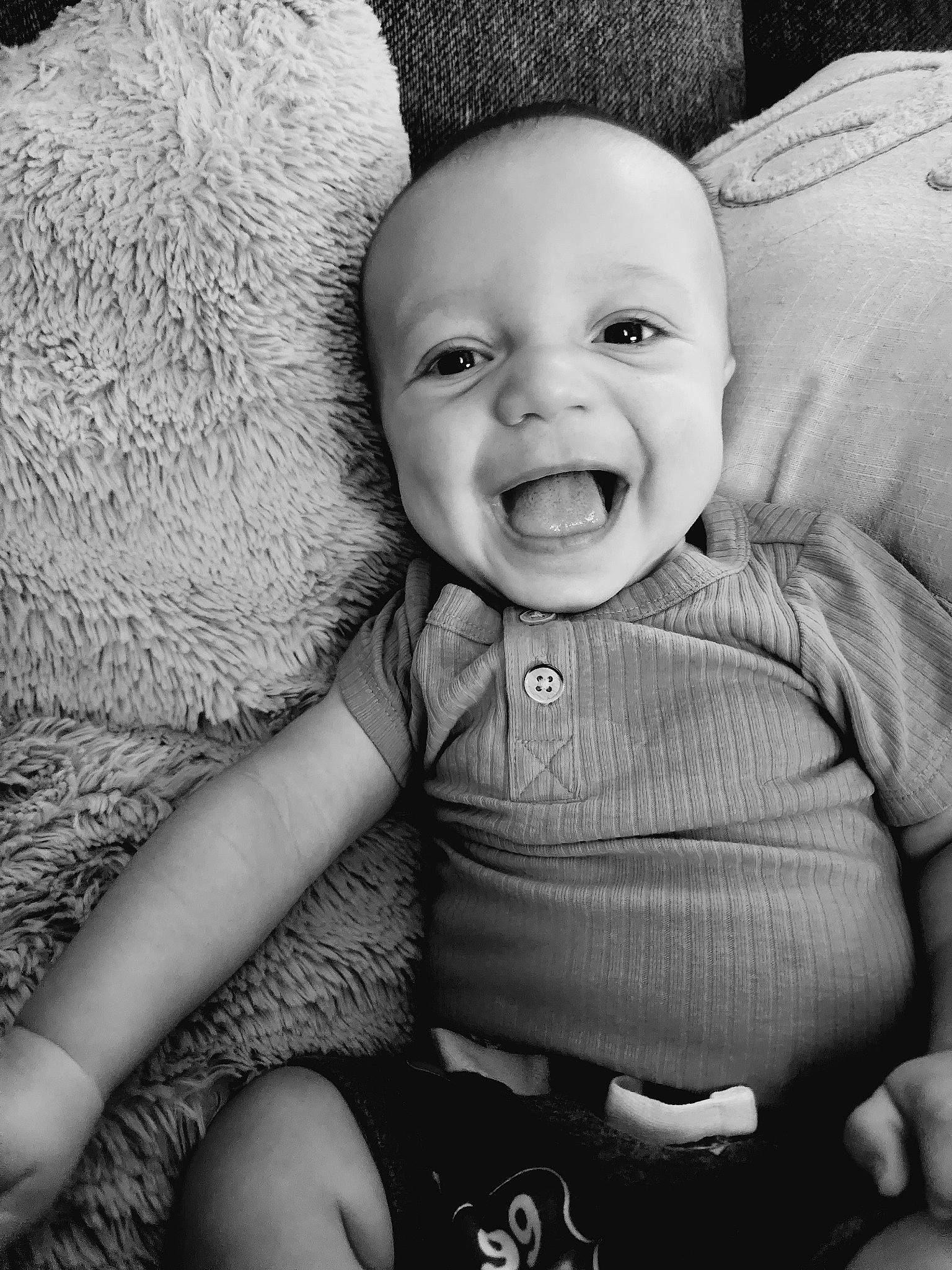 Cooper is registered to the contest to win money with this photo: arm, baby, baby_toddler_clothing, black, cheek, chin, eye, flash_photography, happy, human, iris, lip, mouth, nose, person, photograph, skin, sleeve, smile, style