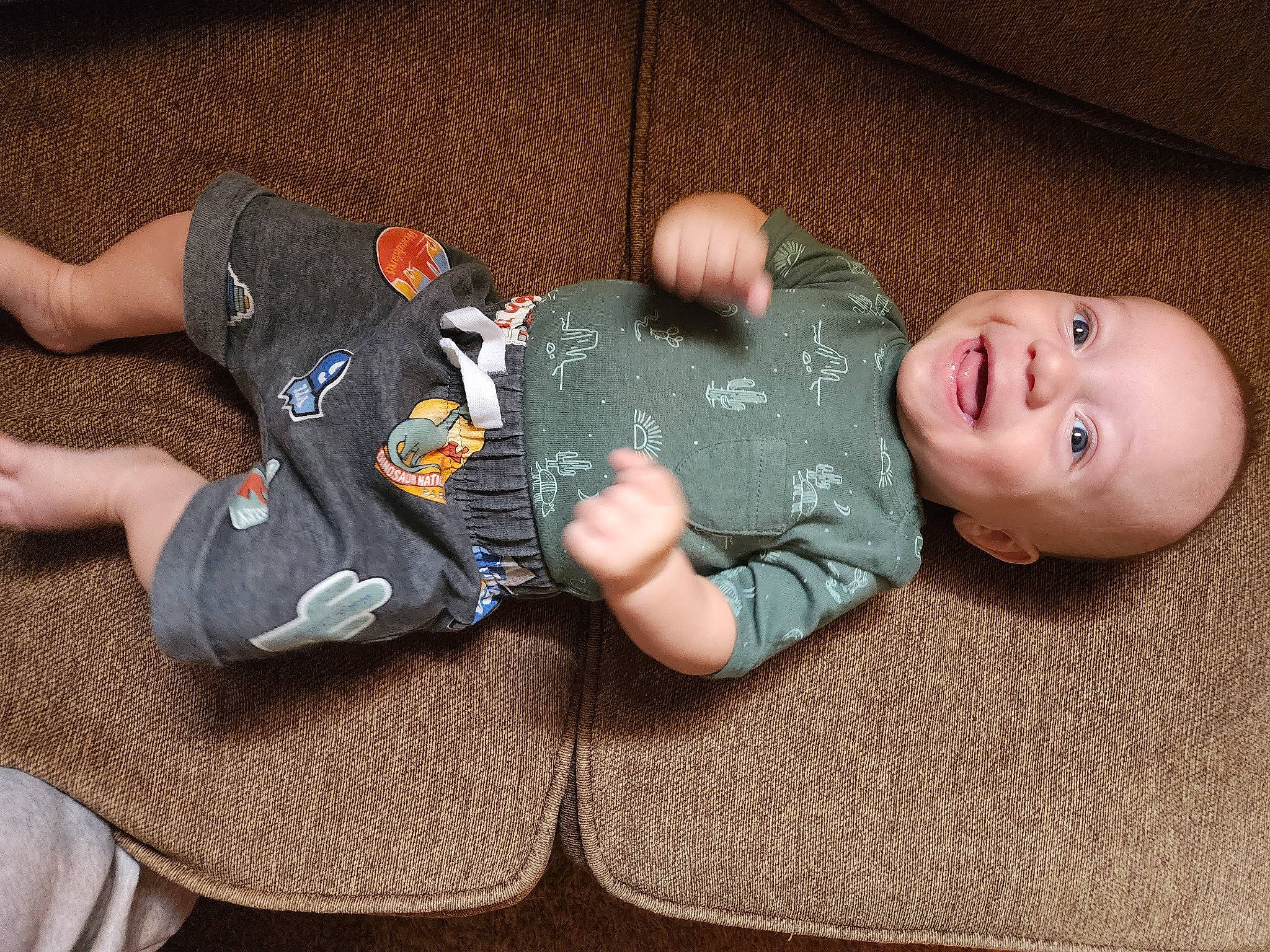 Cooper is registered to the contest to win money with this photo: baby, baby_toddler_clothing, child, comfort, finger, flooring, foot, fun, hand, human_body, human_leg, joint, lap, leg, person, sitting, smile, textile, thigh, toddler