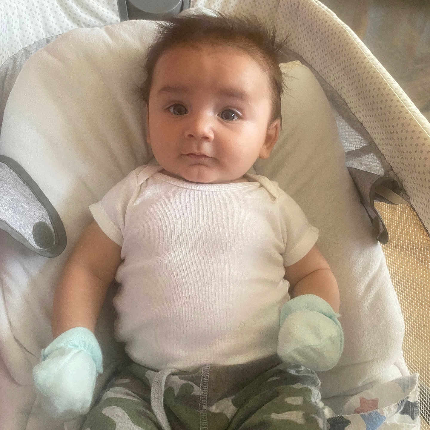 Alfonso Angelo is registered to the contest to win money with this photo: baby, baby_seat, blanket, camo_pants, casual, child, clothing, comfort, cute, expression, face, indoor, infant, mittens, newborn, onesie, portrait, resting, soft_texture, young_child