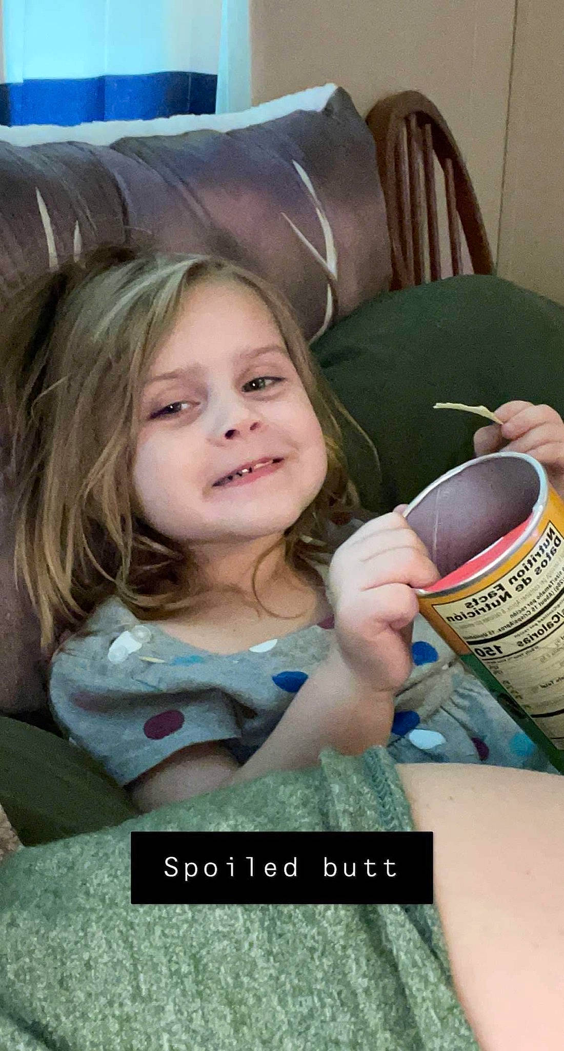 Alyson is registered to the contest to win money with this photo: beauty, brown_hair, child, comfort, cup, drinkware, eyelash, finger, fun, happy, iris, joy, nail, person, photo_caption, room, sitting, skin, smile, textile