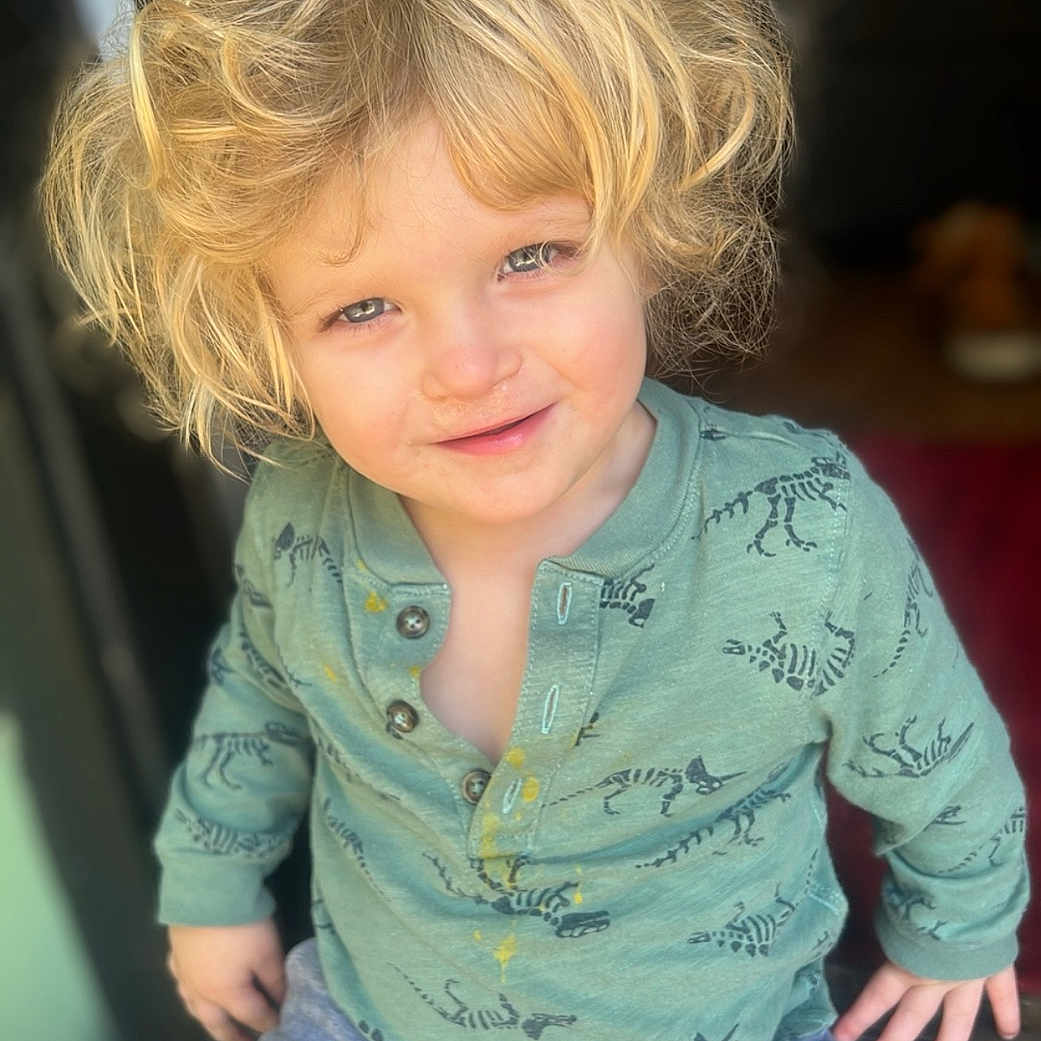 Noah is registered to the contest to win money with this photo: baby, blonde, bodypart, clothing, face, finger, hair, hand, happy, head, jeans, knitwear, longsleeve, pants, person, photography, portrait, sleeve, smile, sweater