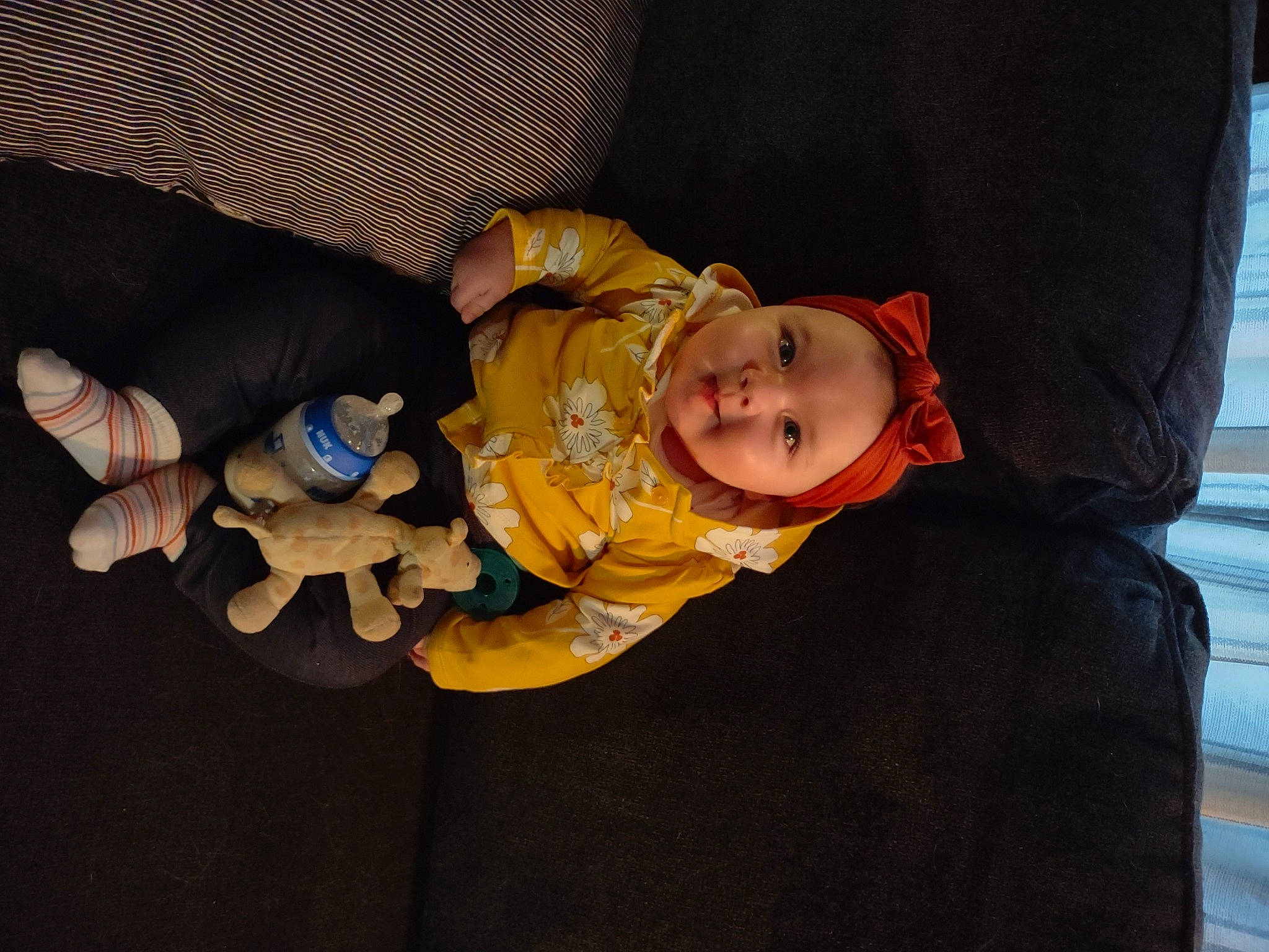 Hazel joined the competition — help win amazing prizes! baby, baby_carriage, baby_products, baby_safety, baby_toddler_clothing, cheek, child, comfort, couch, flooring, fun, hand, headwear, mammal, person, room, sitting, smile, toddler, toy