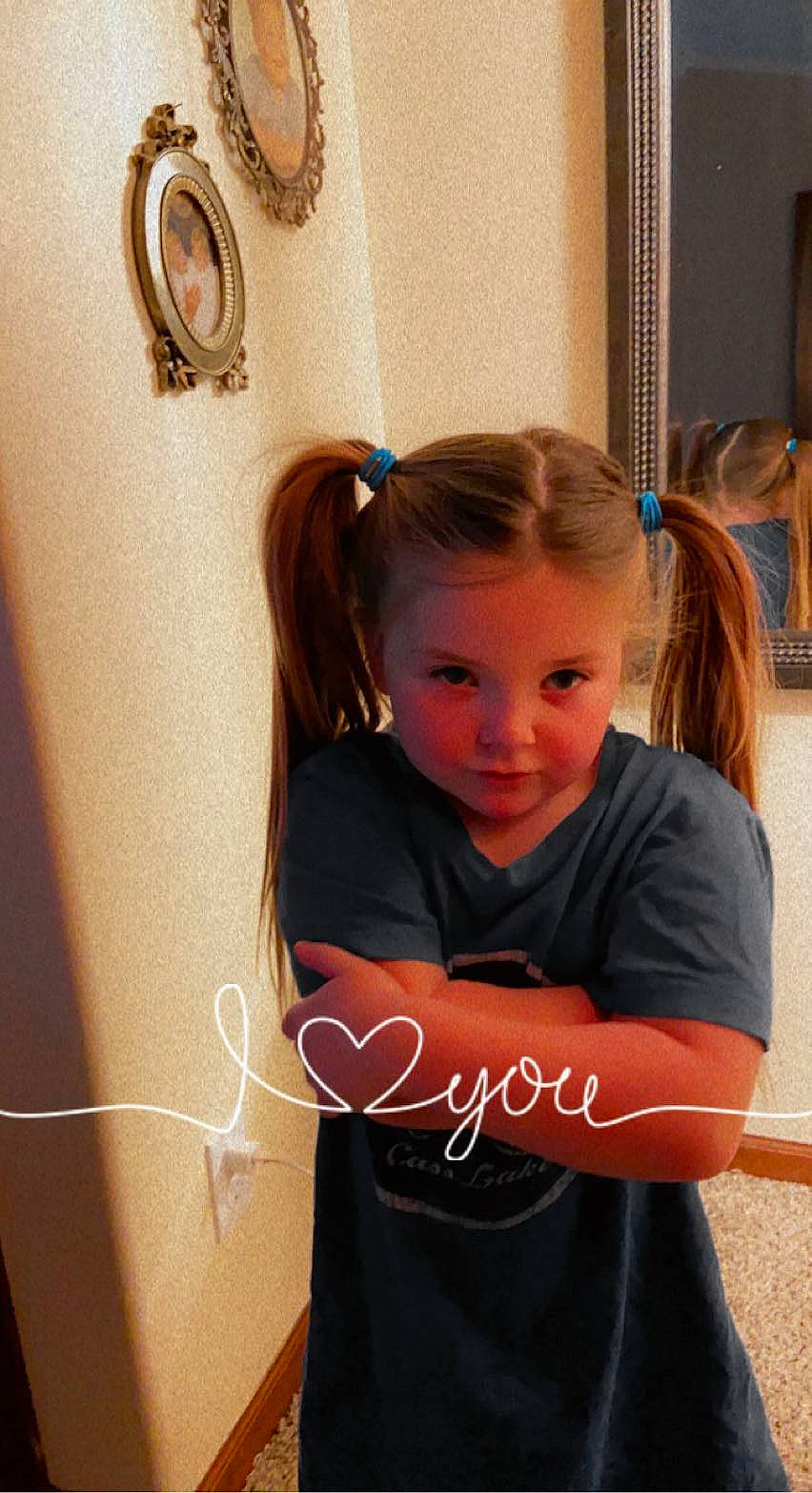 Beckett is registered to the contest to win money with this photo: brown_hair, child, elbow, electric_blue, eyebrow, eyelash, flooring, fun, hair_care, hair_coloring, hairstyle, happy, long_hair, person, room, sitting, sleeve, t_shirt, wood