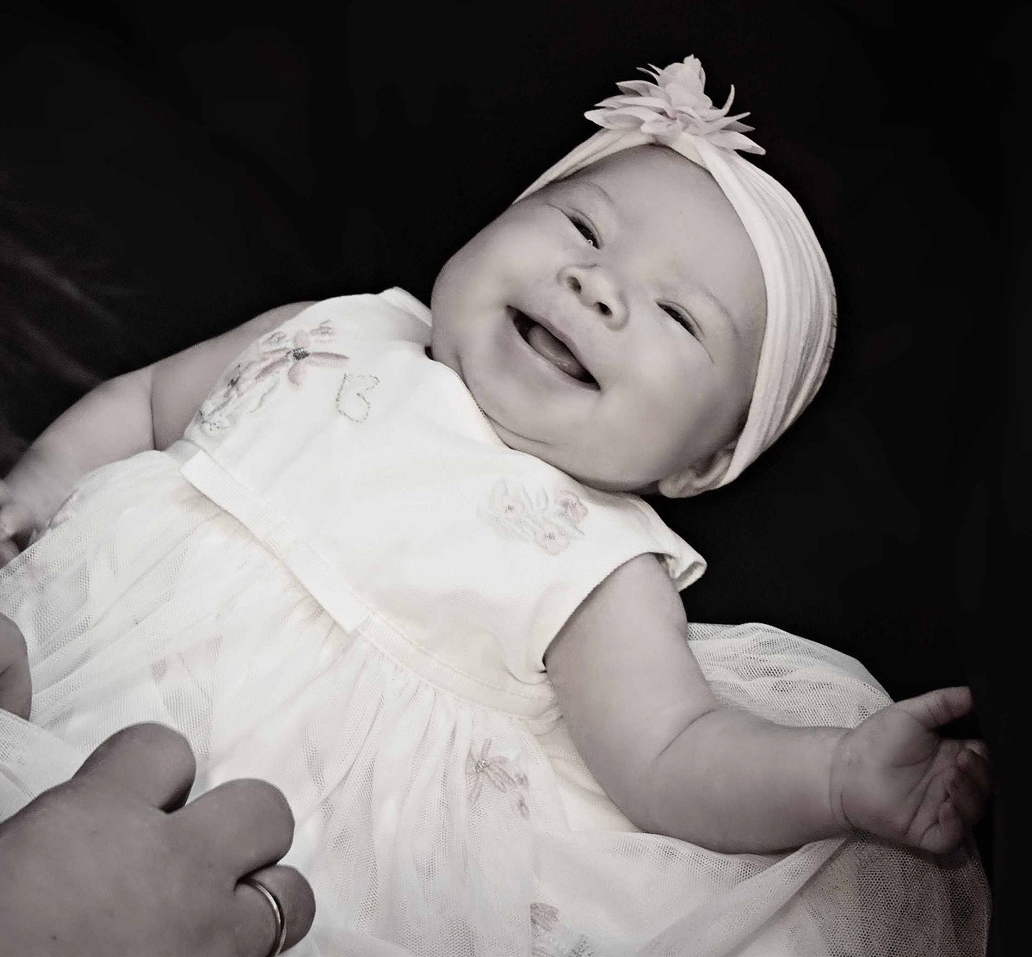 Kylee is registered to the contest to win money with this photo: arm, baby, baby_toddler_clothing, child, comfort, dress, eyebrow, finger, flash_photography, gesture, hand, happy, hat, headpiece, headwear, human_body, iris, lip, person, skin