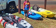 Elias is registered to the contest to win money with this photo: boy, car, child, grass, hat, kayak, kayaks, nature, outdoor, paddle, recreation, road, shorts, sport, summer, sunglasses, sunny, trees, vehicle, water_sport