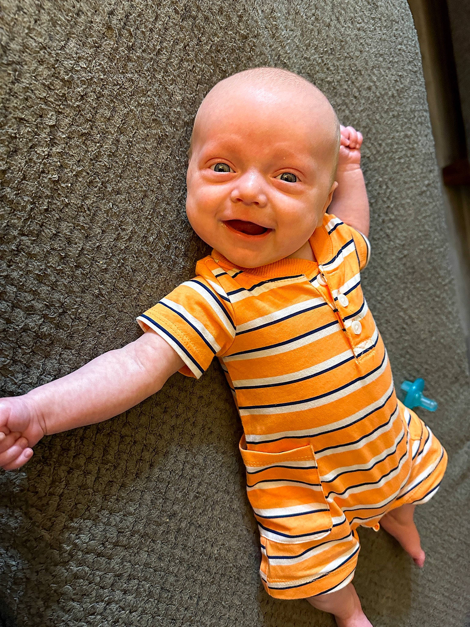 Waylon is registered to the contest to win money with this photo: baby, baby_toddler_clothing, beauty, cheek, eye, face, flooring, fun, gesture, happy, head, nose, orange, people_in_nature, person, skin, sleeve, smile, t_shirt, thumb