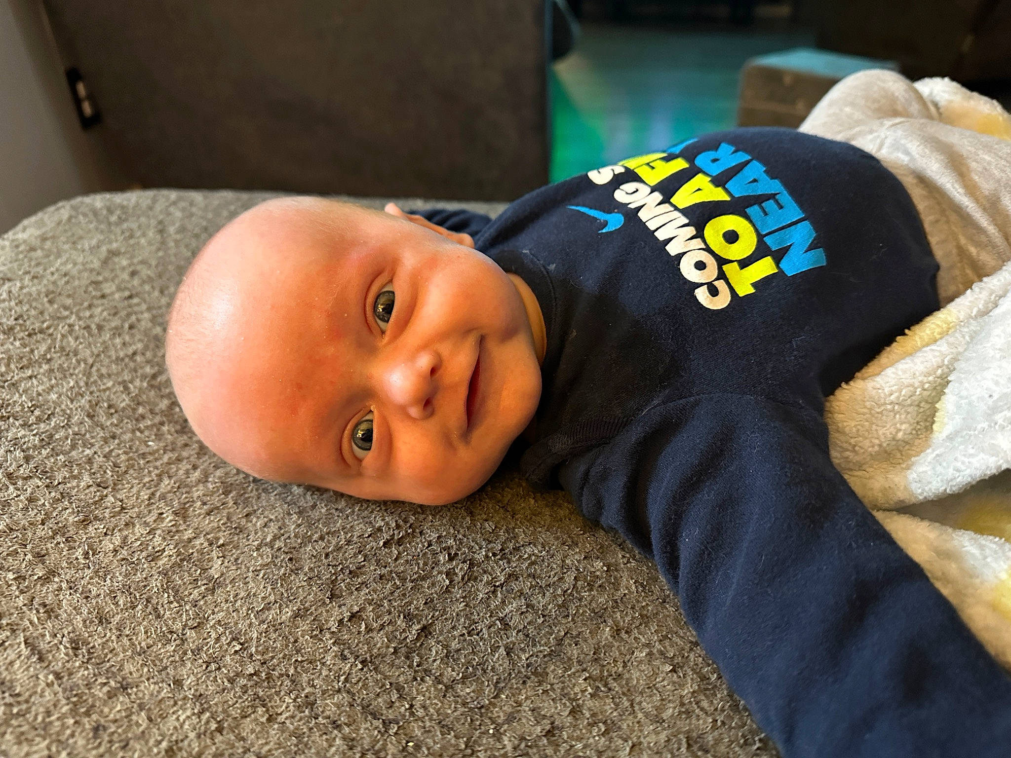 Waylon is registered to the contest to win money with this photo: baby, baby_toddler_clothing, cheek, child, comfort, flooring, grass, person, room, sitting, sleeve, smile, toddler, wood