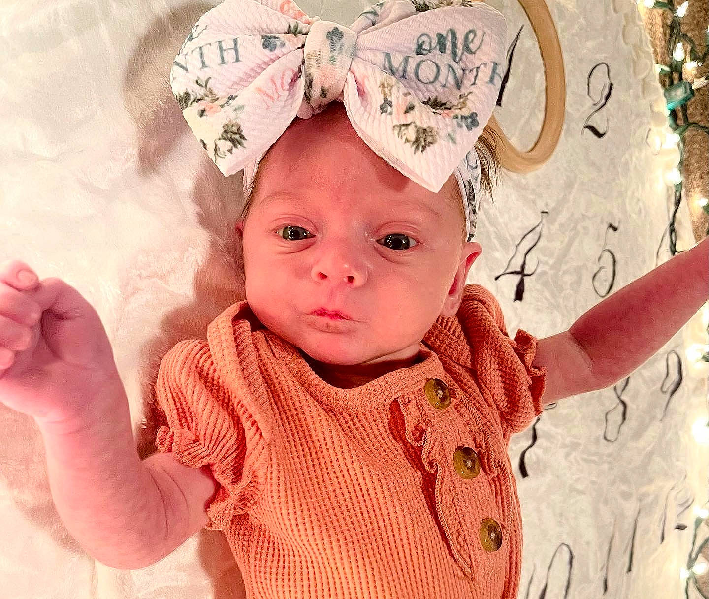 Jersey is registered to the contest to win money with this photo: baby, baby_toddler_clothing, cheek, eyelash, facial_expression, finger, gesture, happy, head, headgear, headwear, human, lip, mouth, nose, organ, person, pink, skin, sleeve