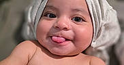 Elijah joined the competition — help win amazing prizes! baby, infant, tongue_out, cute, smile, hat, headwear, skin, bare_chest, closeup, portrait, child, happy, playful, indoors, soft_light, expression, face, young, human