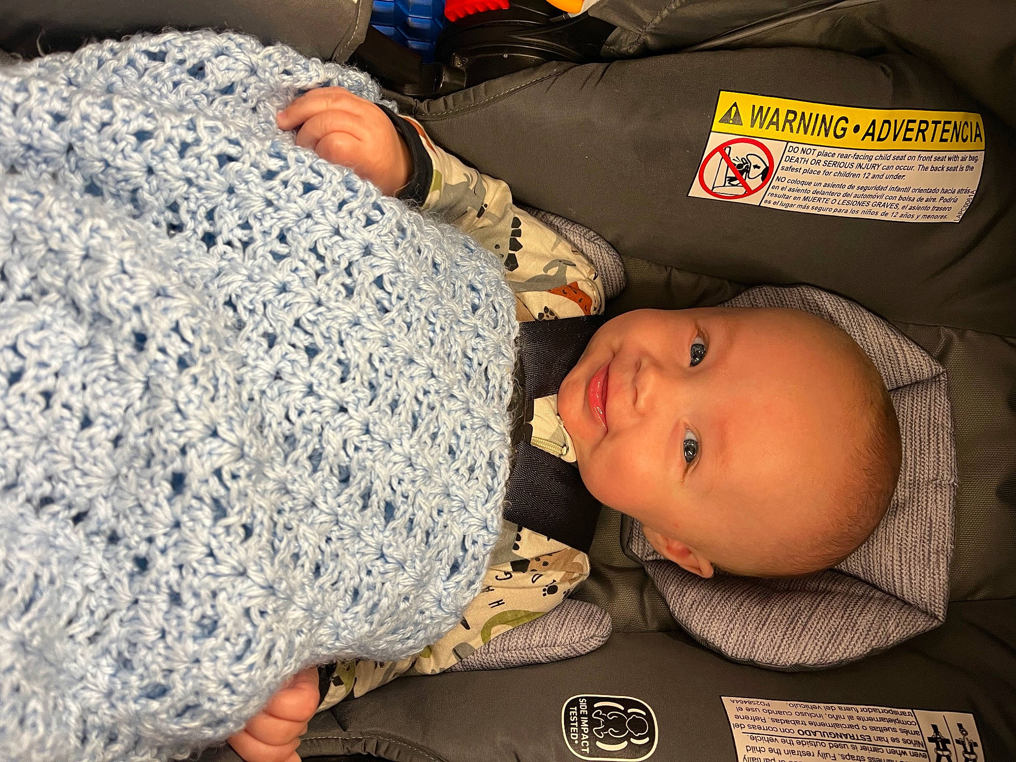 Nash is registered to the contest to win money with this photo: art, baby, baby_toddler_clothing, child, comfort, craft, creative_arts, fashion_accessory, hat, head, headgear, organ, pattern, person, room, smile, thread, toddler, wool, woolen