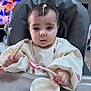 baby, high_chair, yogurt, spoon, messy, food, feeding, child, cute, face, expression, clothing, indoor, table, hands, plastic_container, feeding_time, toddler, funny, mess