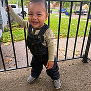 Jayden joined the competition — help win amazing prizes! child, toddler, smiling, happy, portrait, outdoors, porch, railing, autumn, leaves, overalls, denim, shirt, shoes, standing, neighborhood, house, street, trees, daylight
