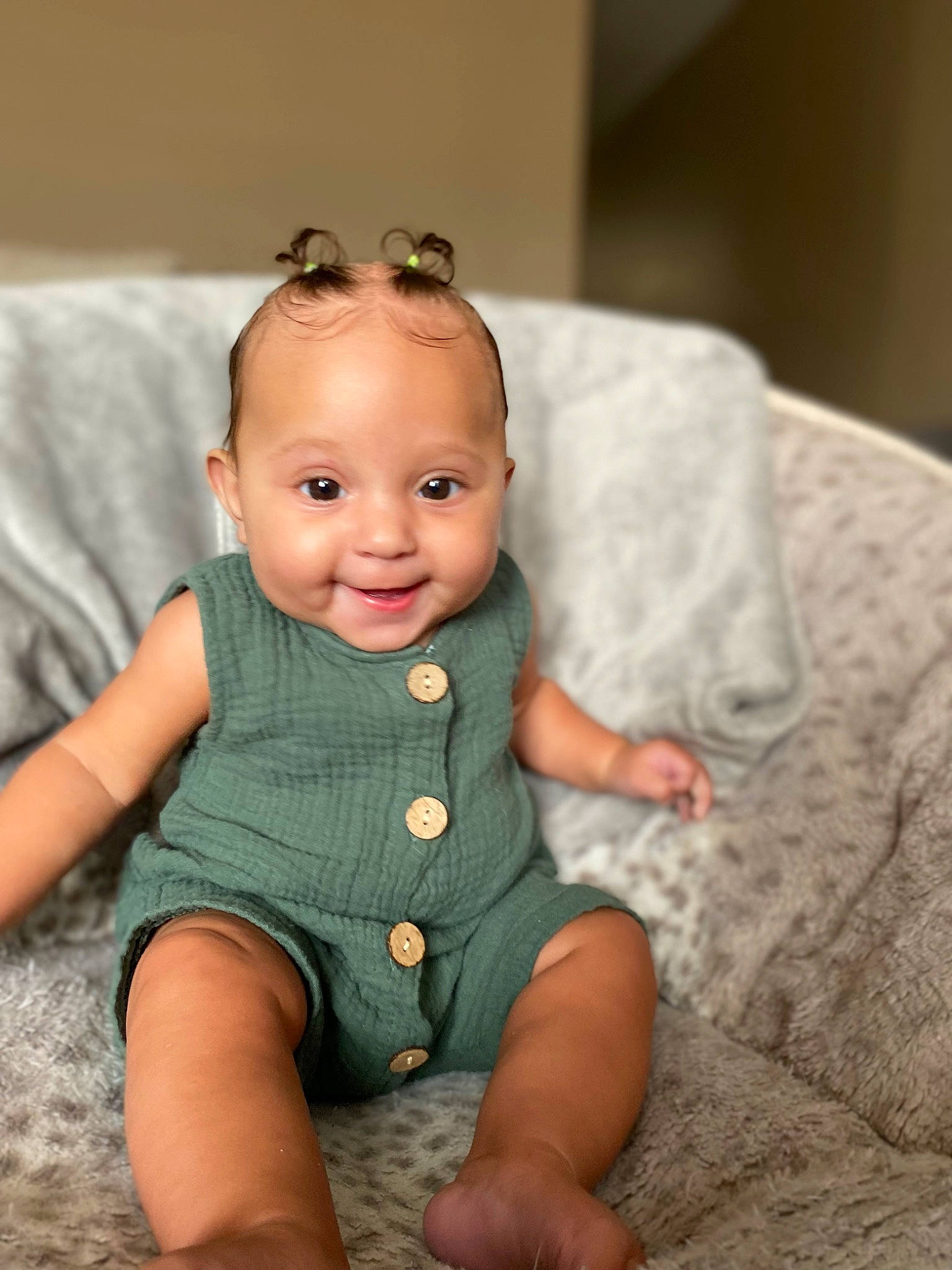 Syrah is registered to the contest to win money with this photo: arm, baby, baby_toddler_clothing, cheek, chin, clothing, comfort, dress, eye, face, finger, flash_photography, happy, head, headgear, iris, joy, person, skin, sleeve