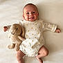 baby, smiling, infant, stuffed_animal, bunny, toy, onesie, pattern, bee, blanket, lying_down, cute, happy, child, face, skin, soft, indoor, portrait, playful