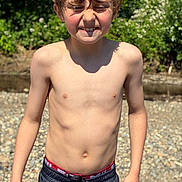 Declan is registered to the contest to win money with this photo: boy, child, shirtless, outdoor, sunlight, nature, greenery, rocks, summer, smile, face, hair, shorts, skin, person, young, happy, casual, daylight, portrait